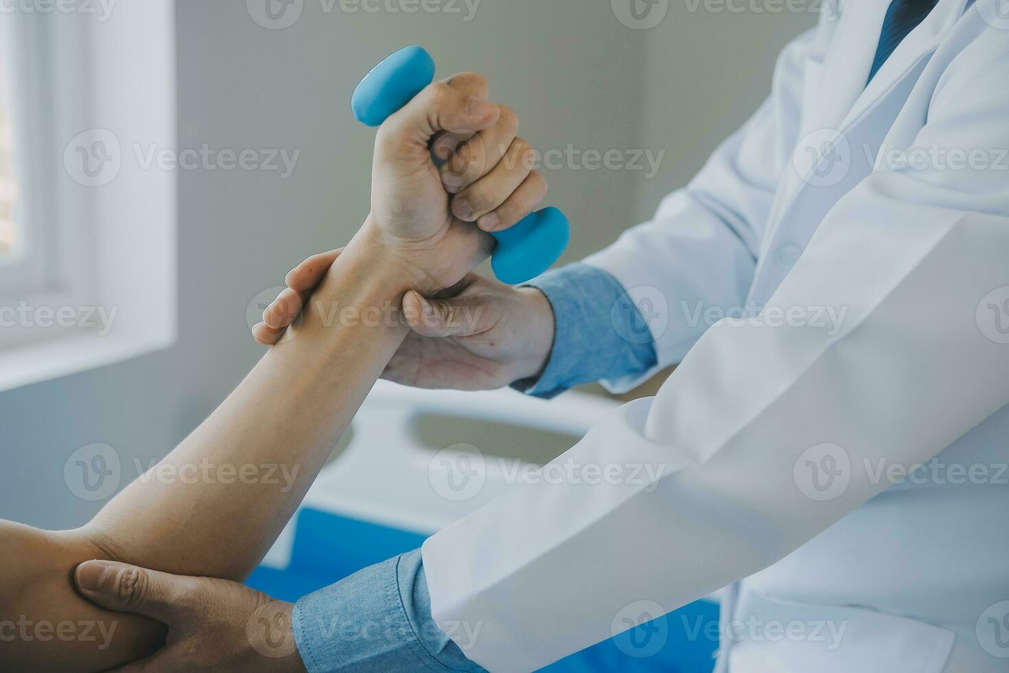 Doctor or physical therapist examines back pain and spinal area to give advice within the rehabilitation center. photo