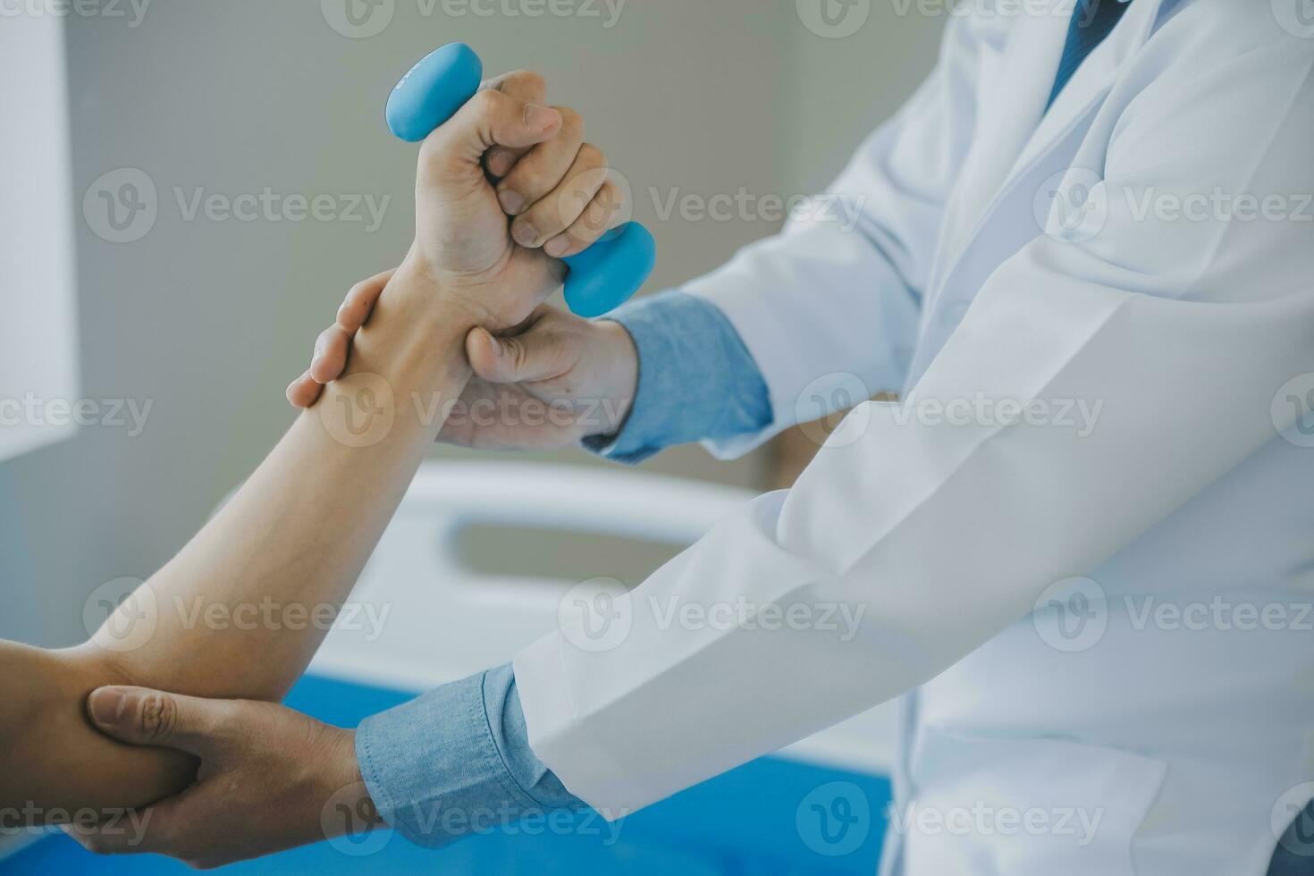 Doctor or physical therapist examines back pain and spinal area to give advice within the rehabilitation center. photo