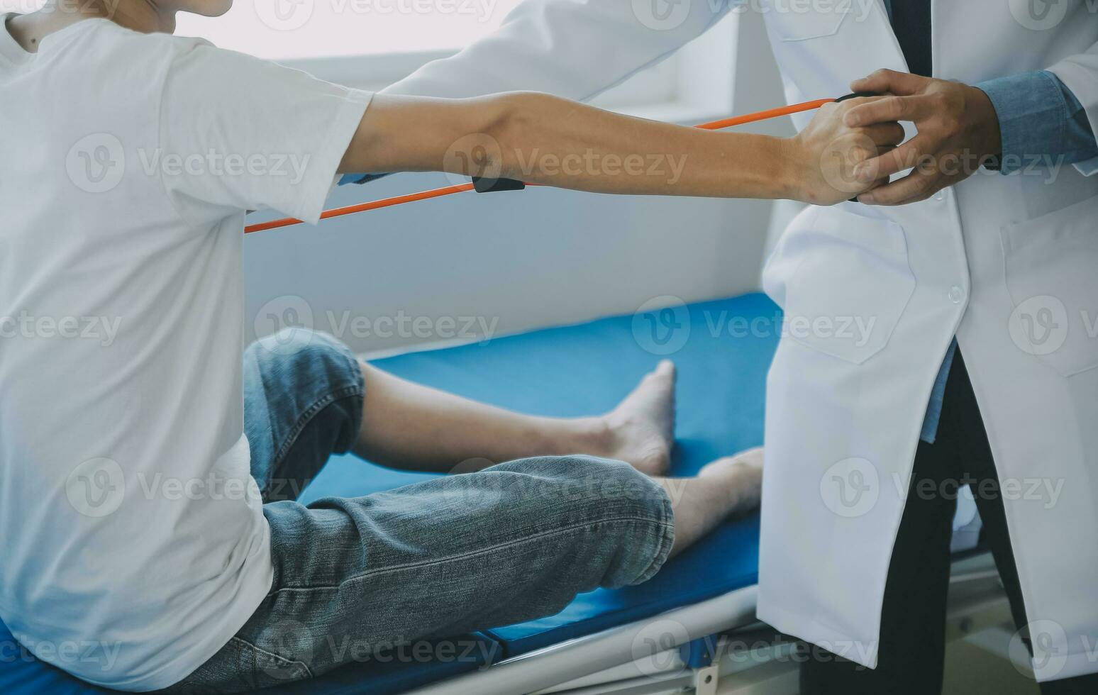 Doctor or physical therapist examines back pain and spinal area to give advice within the rehabilitation center. photo