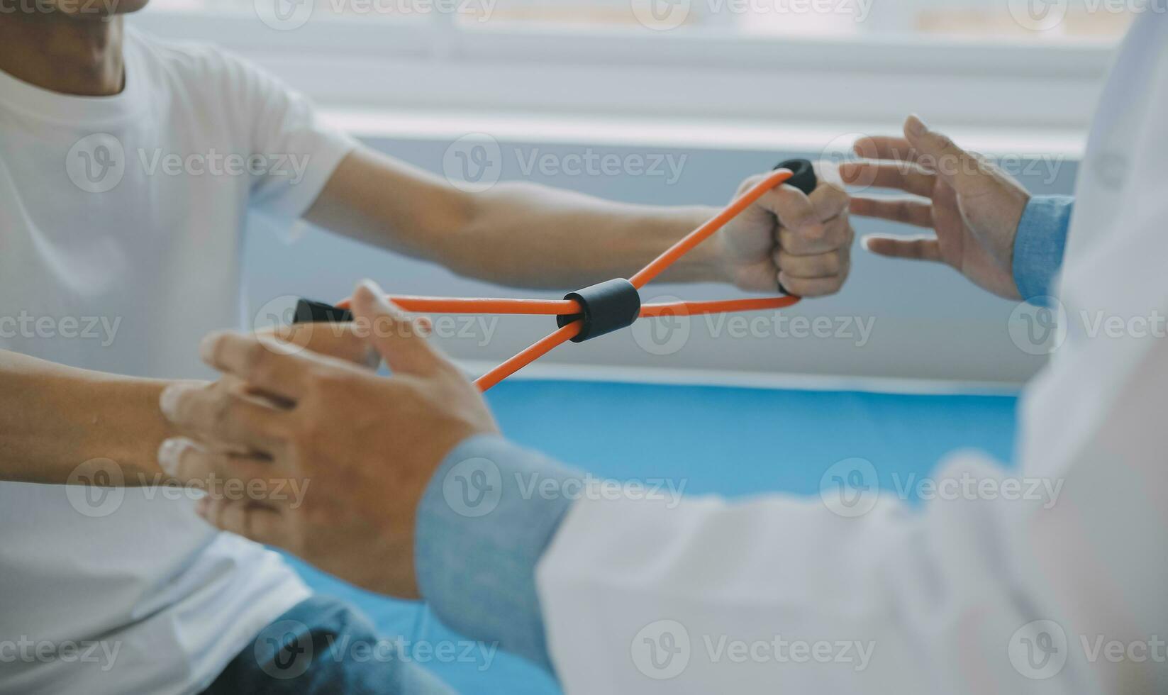 Doctor or physical therapist examines back pain and spinal area to give advice within the rehabilitation center. photo