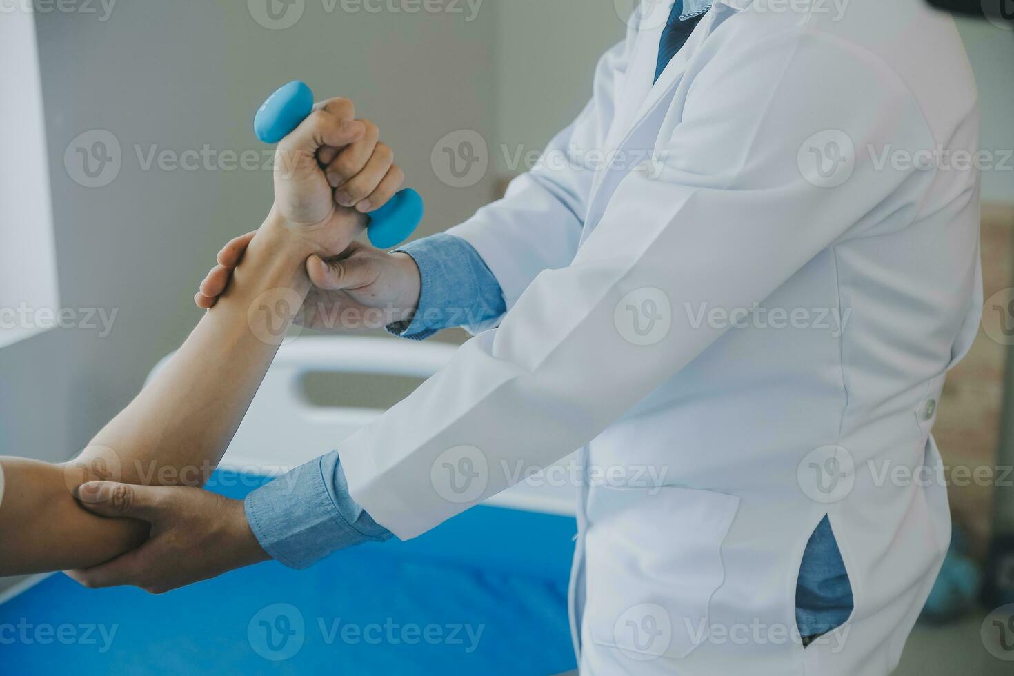 Doctor or physical therapist examines back pain and spinal area to give advice within the rehabilitation center. photo