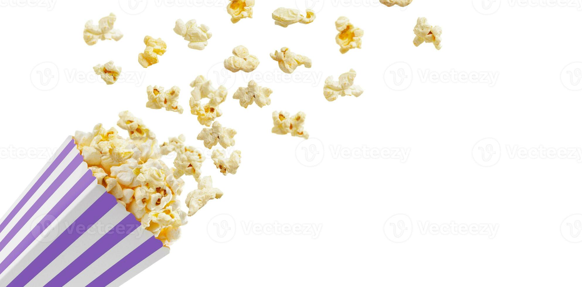 Popcorn flying out of purple white striped paper box, isolated on white background photo