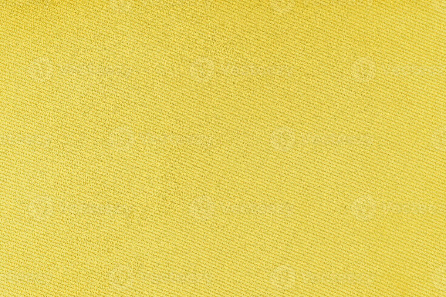 Texture of yellow fabric diagonal weave pattern. Decorative textile background photo