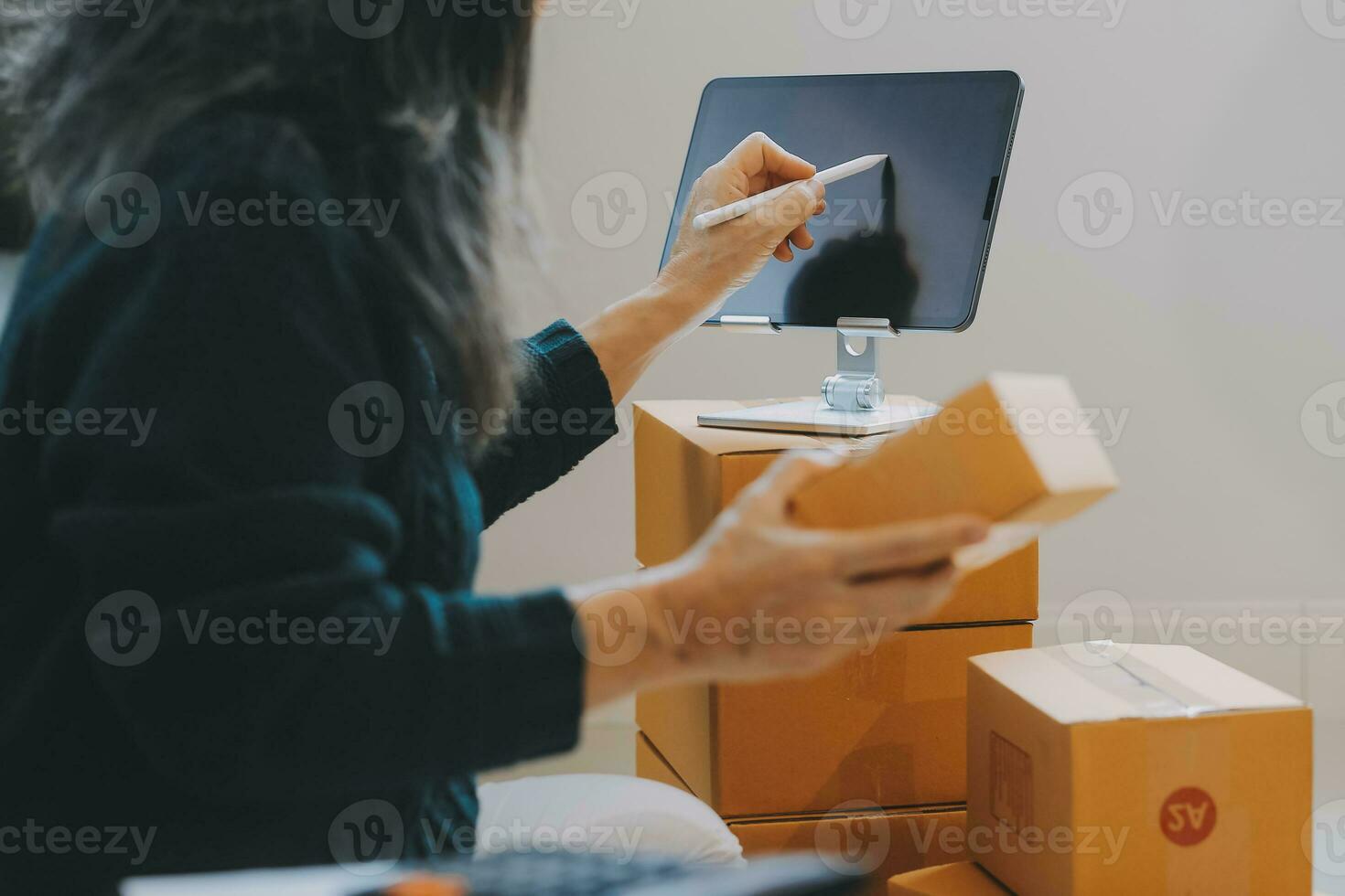 Entrepreneurs Small Business SME Independent men work at home Use smartphones and laptops for commercial checking, online marketing, packing boxes, SME sellers, concept, e-commerce team, online sales photo