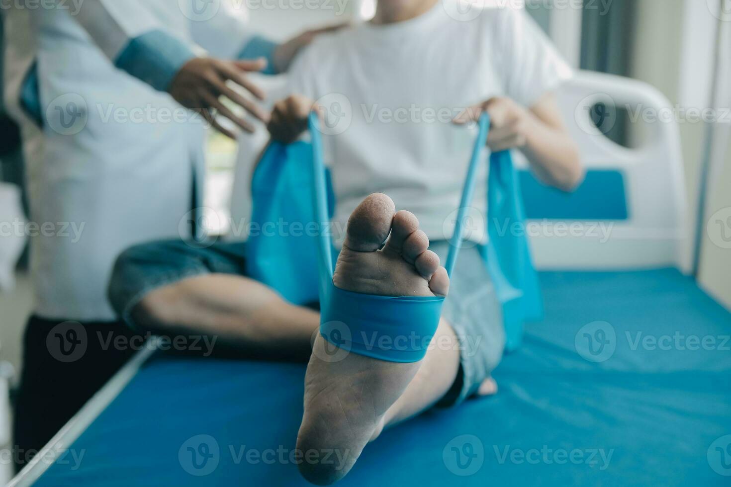 Doctor or physical therapist examines back pain and spinal area to give advice within the rehabilitation center. photo