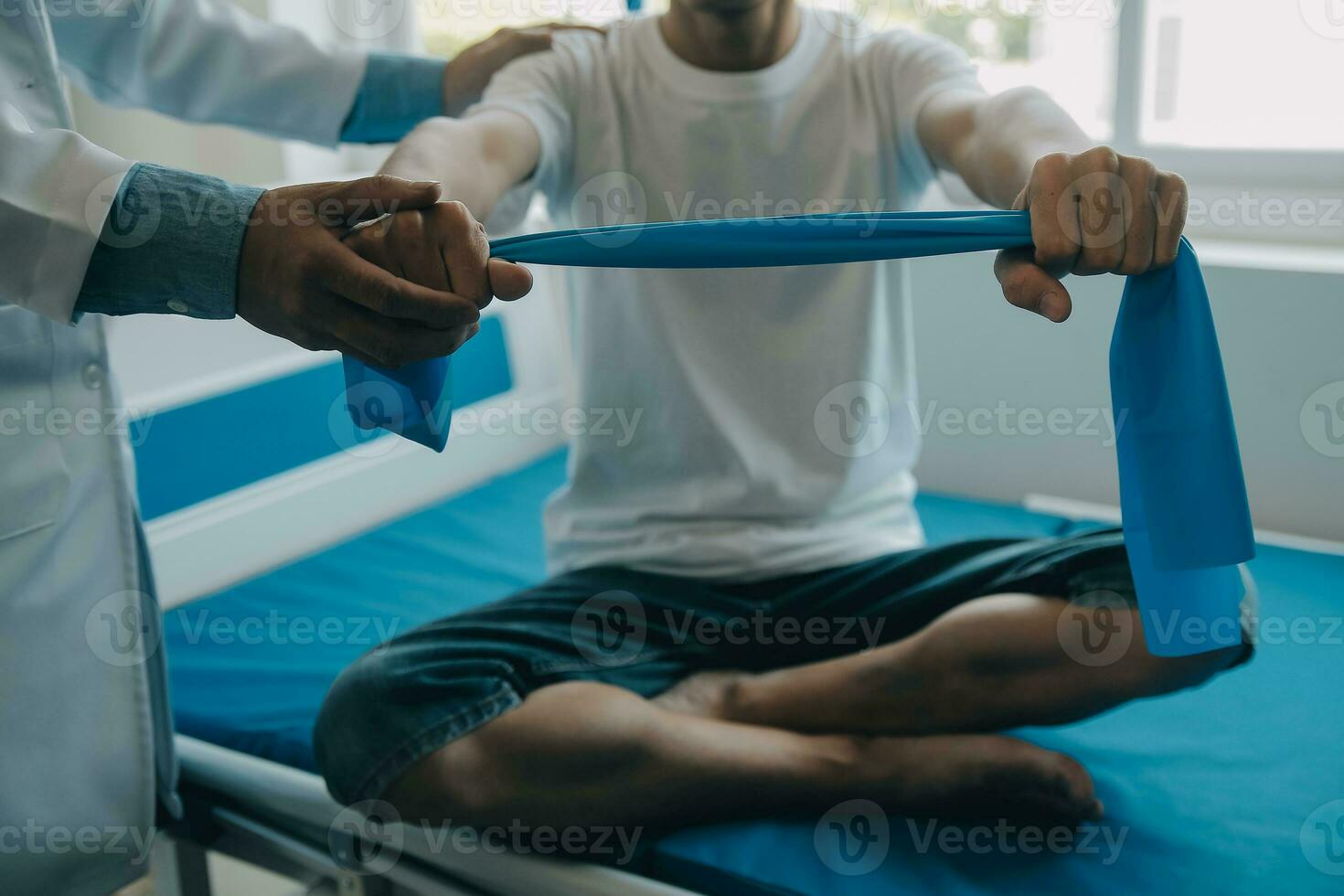 Doctor or physical therapist examines back pain and spinal area to give advice within the rehabilitation center. photo