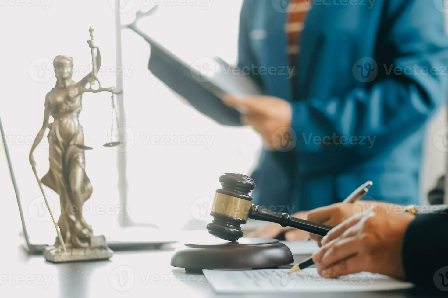Business and lawyers discussing contract papers with brass scale on desk in office. Law, legal services, advice, justice and law concept picture with film grain effect photo
