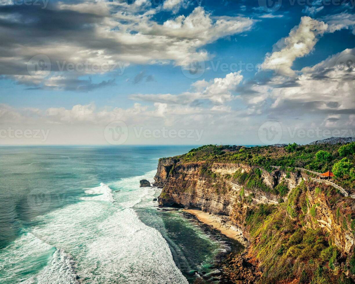 Cliff in ocean on sunset photo