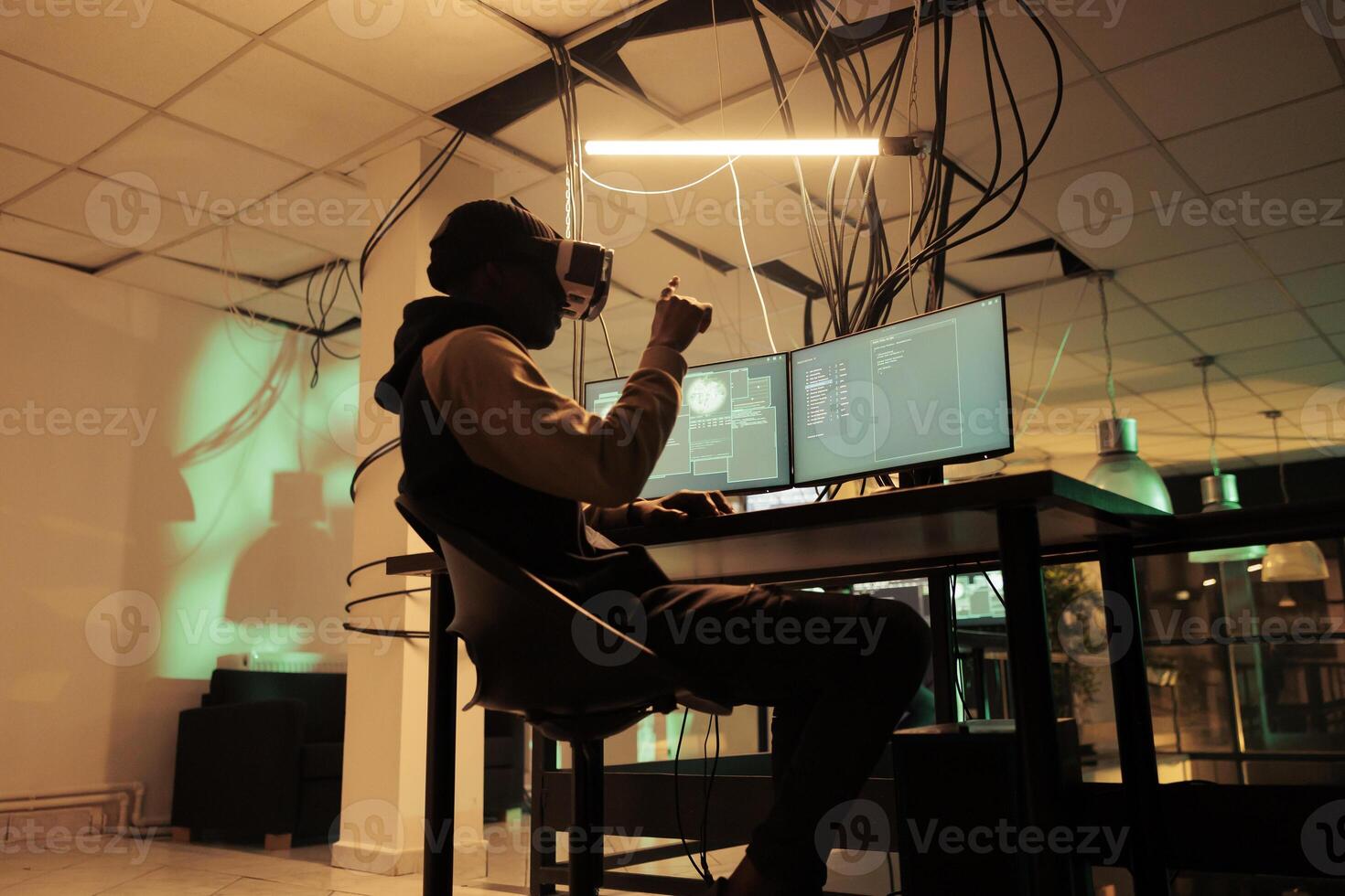 Criminal coding malware in virtual reality, cracking database password in metaverse, hacking online server, stealing electronic information. Cybercrime, hacker in vr helmet at night time photo