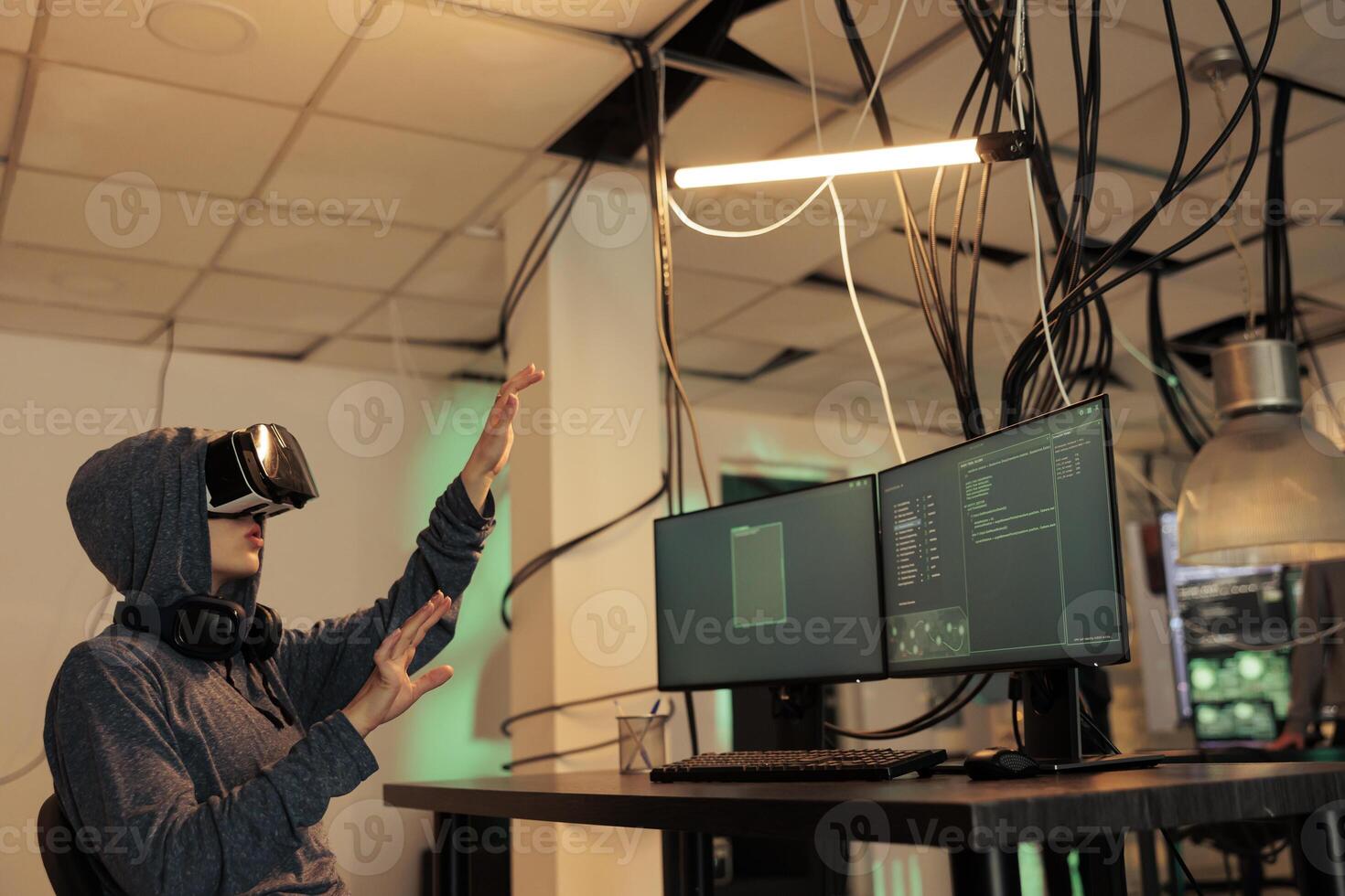 Hacker coding spyware in vr, cracking password in metaverse, hacking server, stealing electronic information. Cyberattack, internet criminal developing malware in virtual reality headset photo