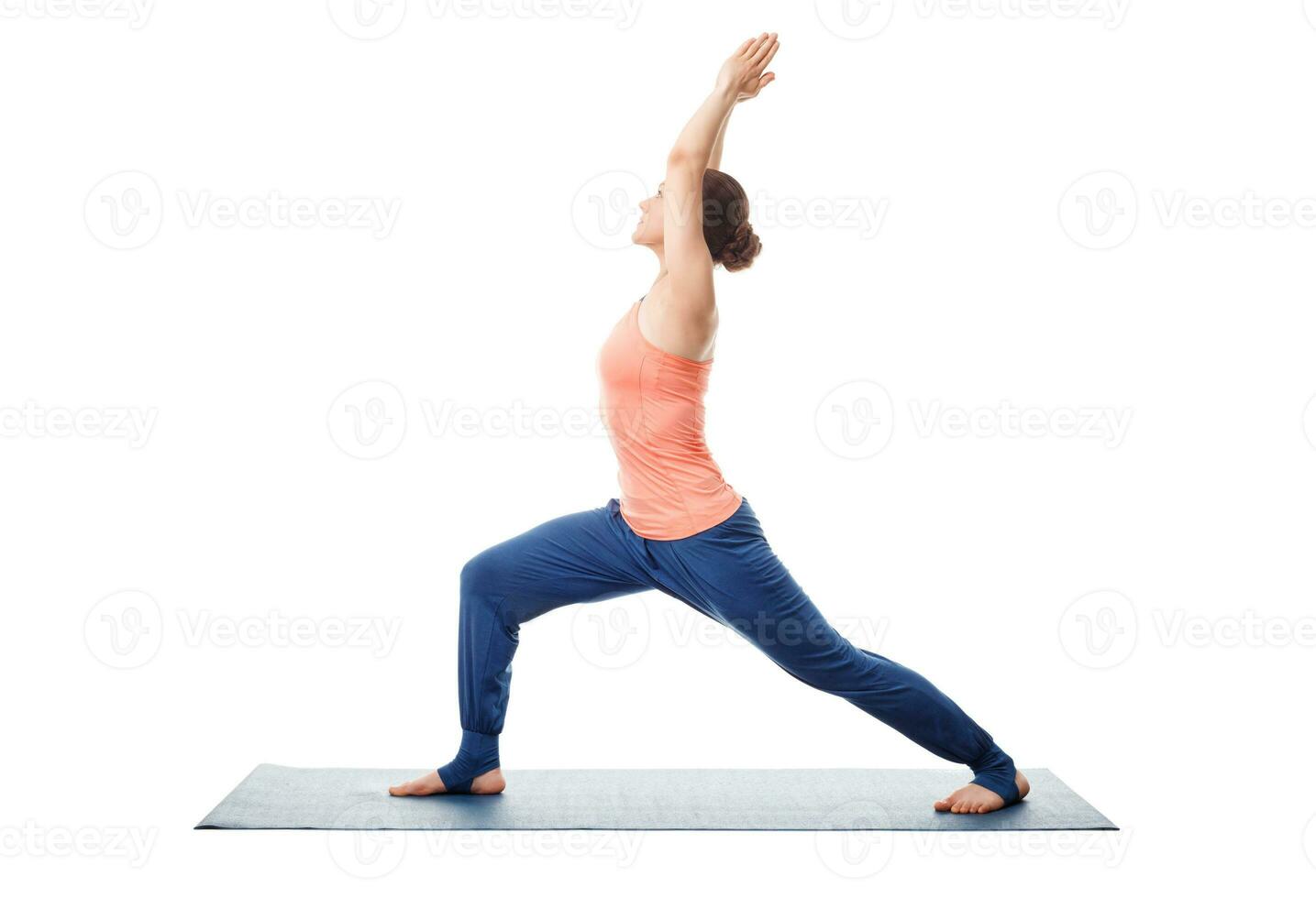 Woman practices yoga Warrior asana photo