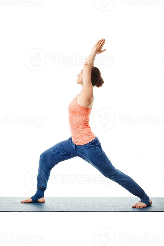 Woman practices yoga asana utthita Virabhadras photo