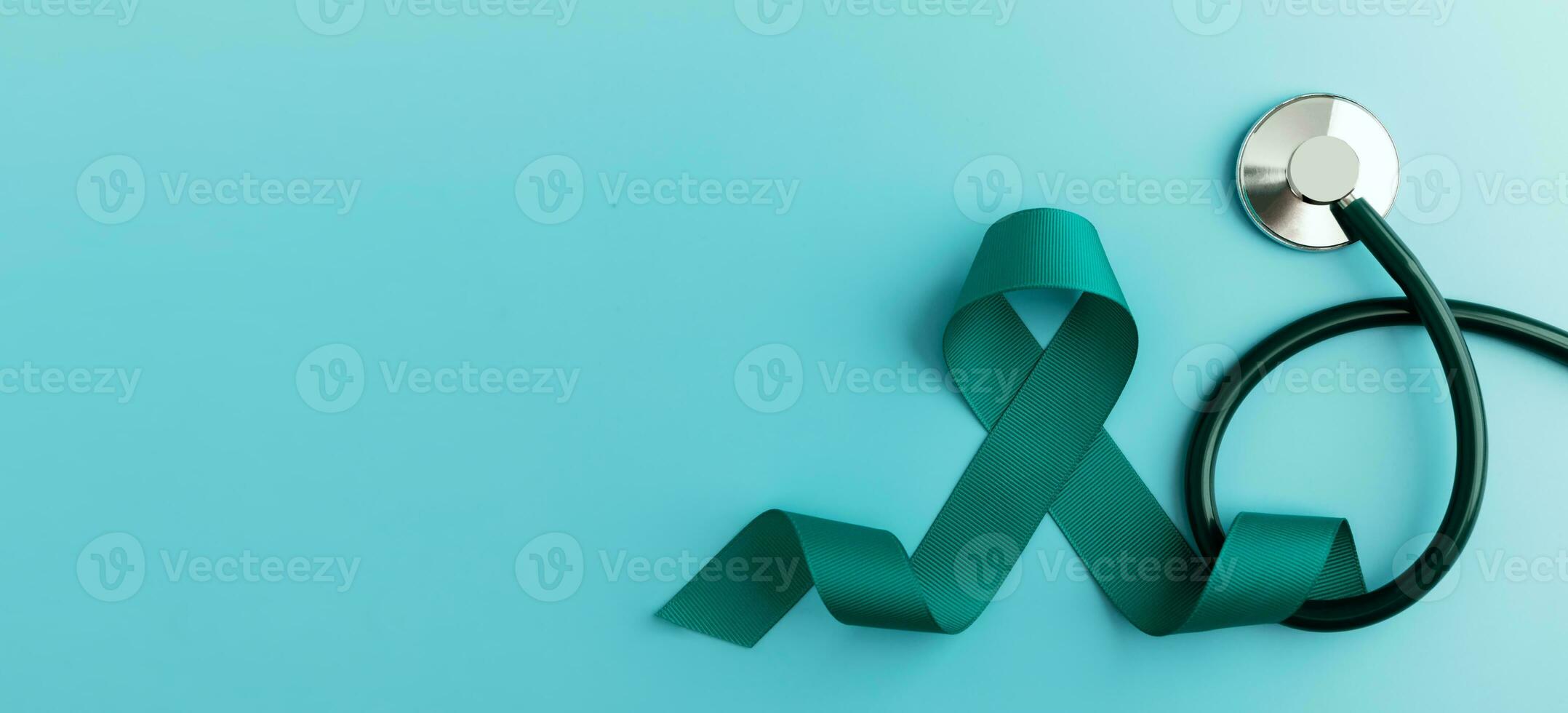 Ovarian and Cervical Cancer Awareness. a Teal Ribbonin with Stethoscope in Top View. Uterus, Female Reproductive System, Women's Health, PCOS and Gynecology photo