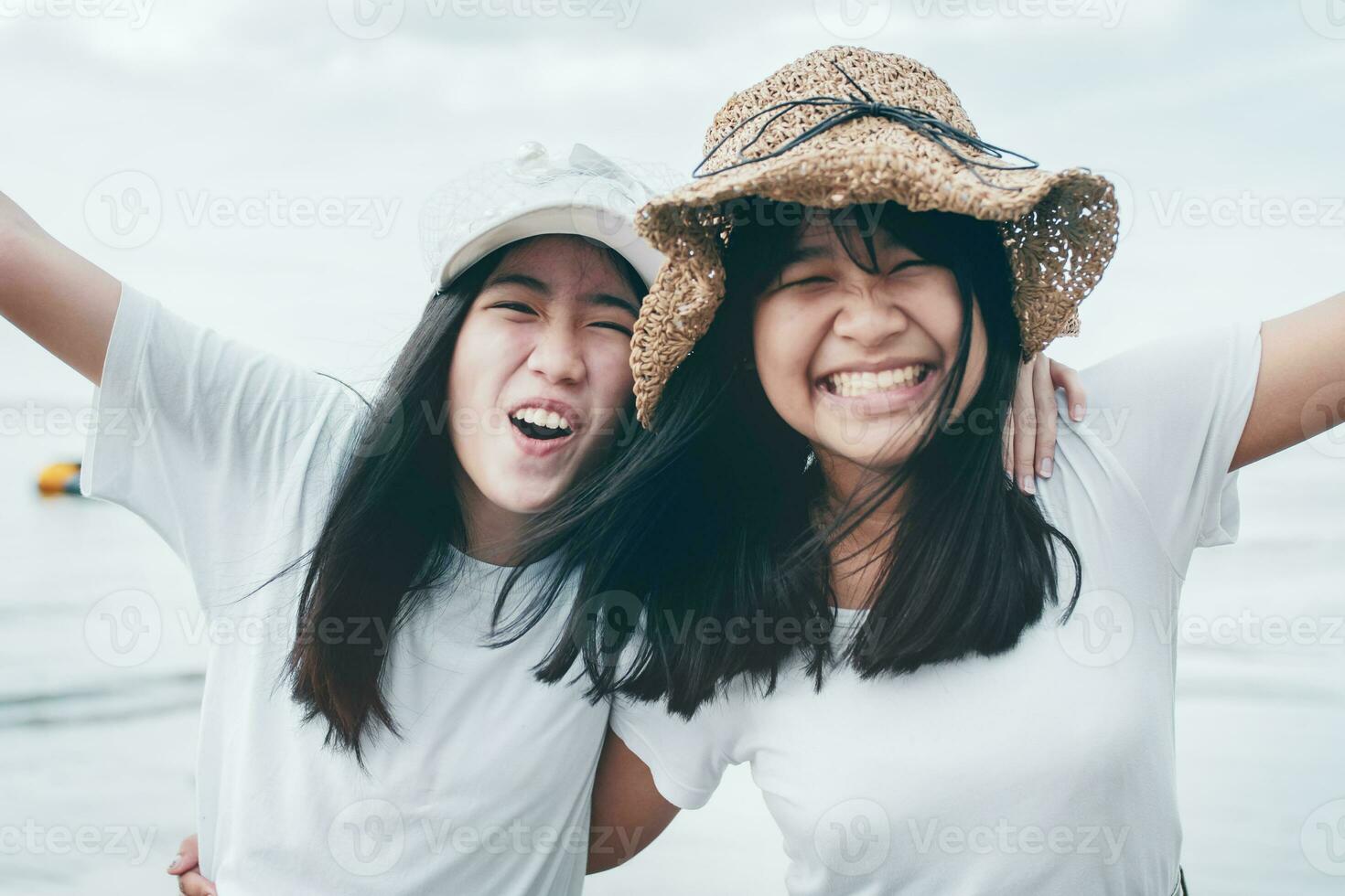 two cheerful asian teenager happiness on vacation sea beach photo