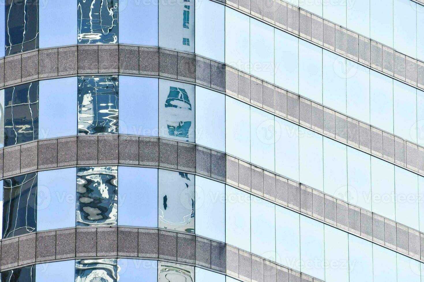 reflections of the city in the windows of a building photo