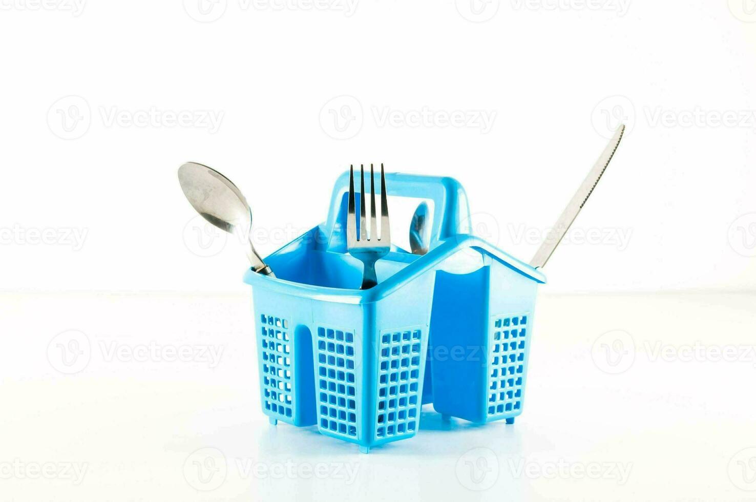 a blue plastic utensil holder with forks and spoons photo