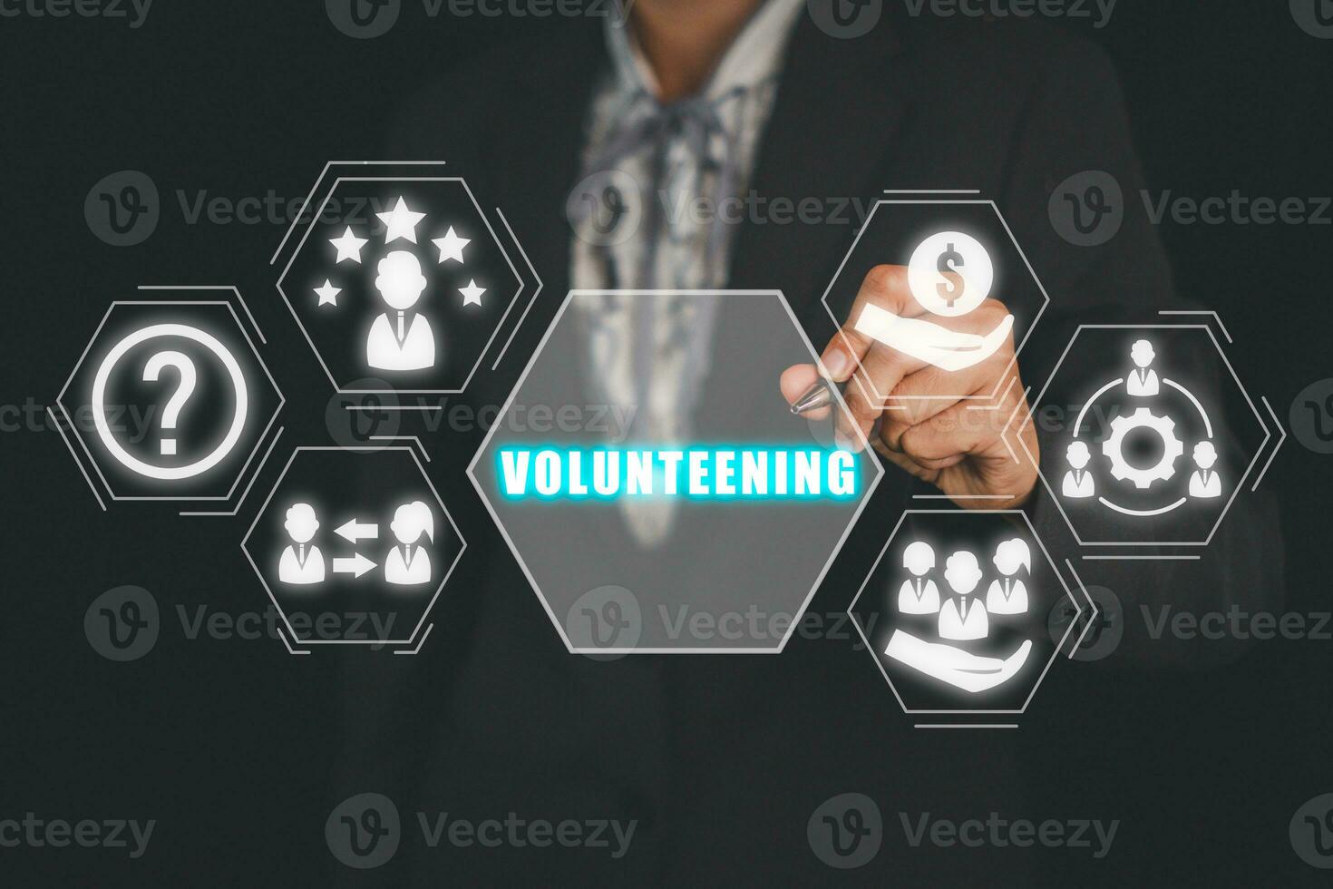 Volunteening concept, Businesswoman hand touching volunteening icon on virtual screen. photo