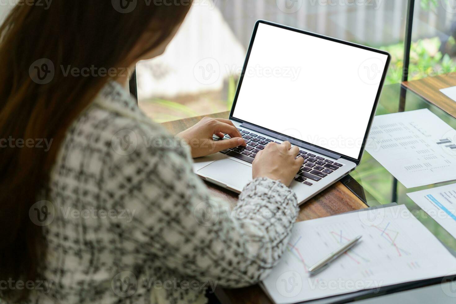 Woman Working by using laptop blank screen computer . Hands typi photo