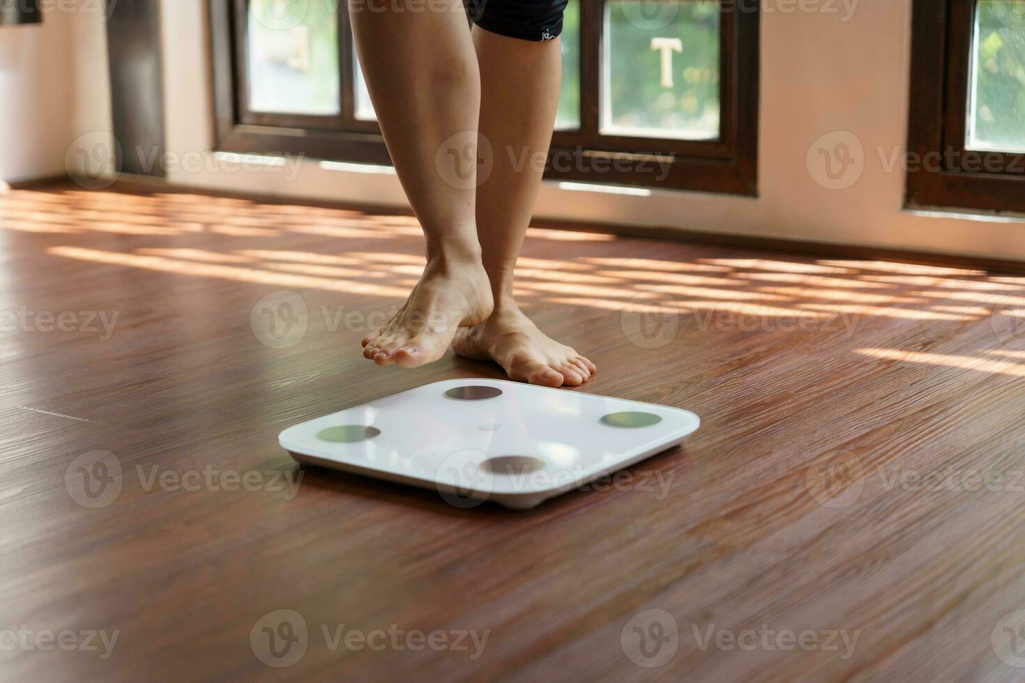 Fat diet and scale feet standing on electronic scales for weight control. Measurement instrument in kilogram for a diet control photo