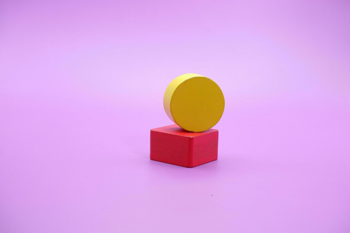 Set of colorful wooden shape toy. Square and round on Purple background photo