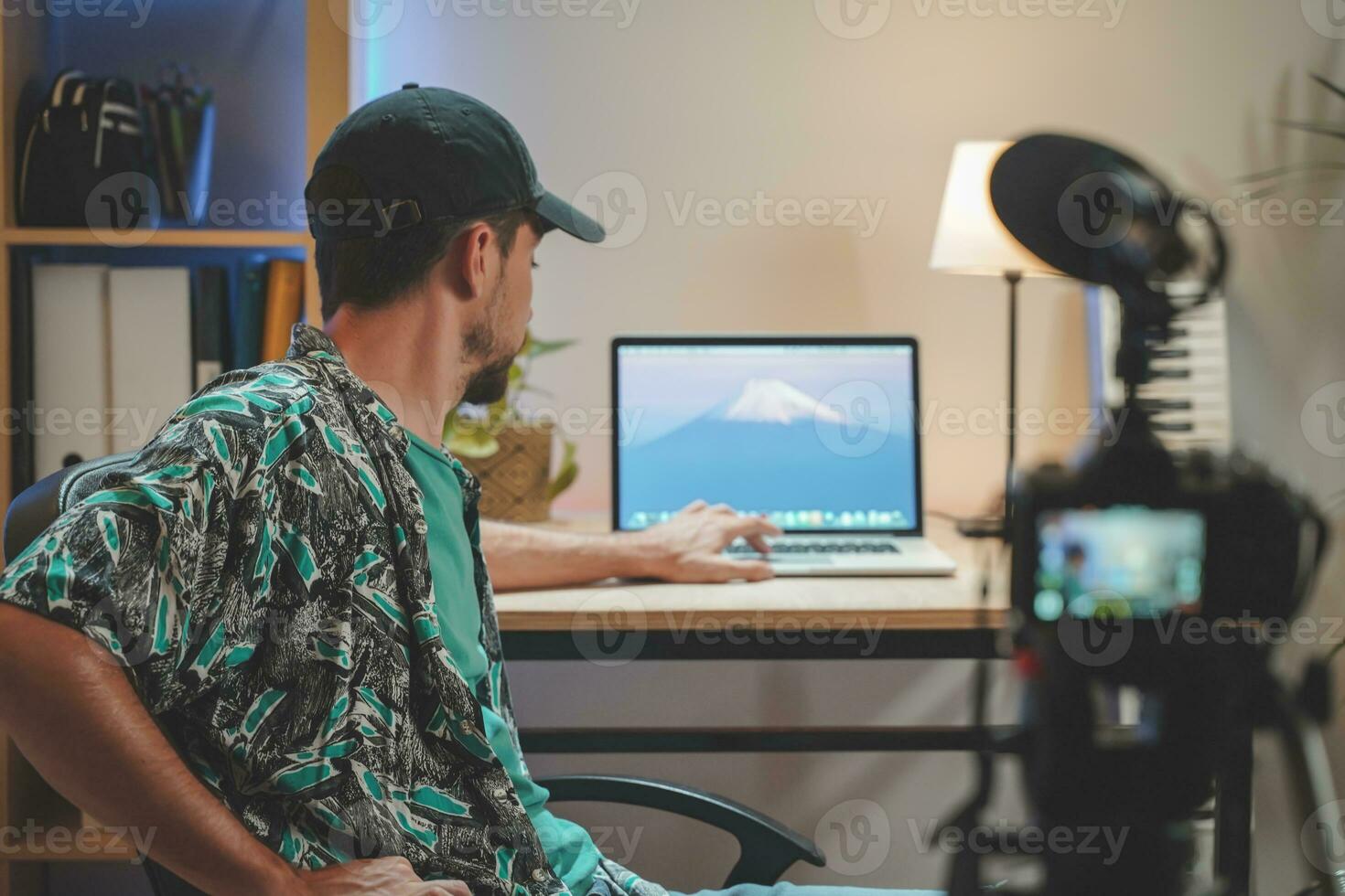 Behind the scene shot of a young man influencer making a video photo