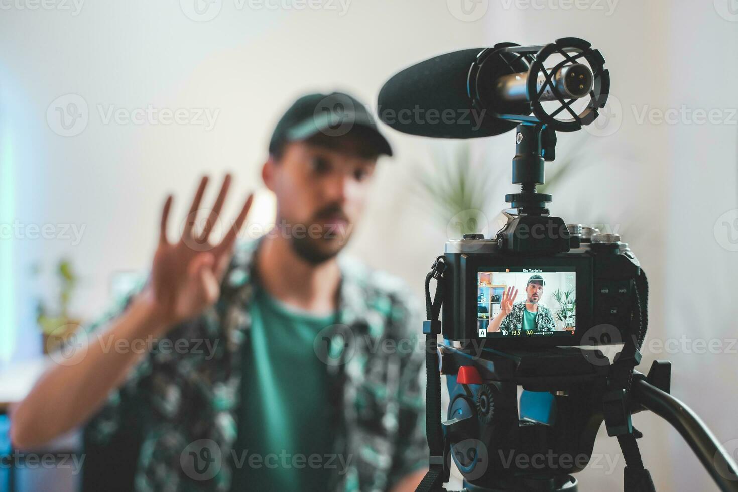 Behind the scene shot of a young man influencer making a video photo