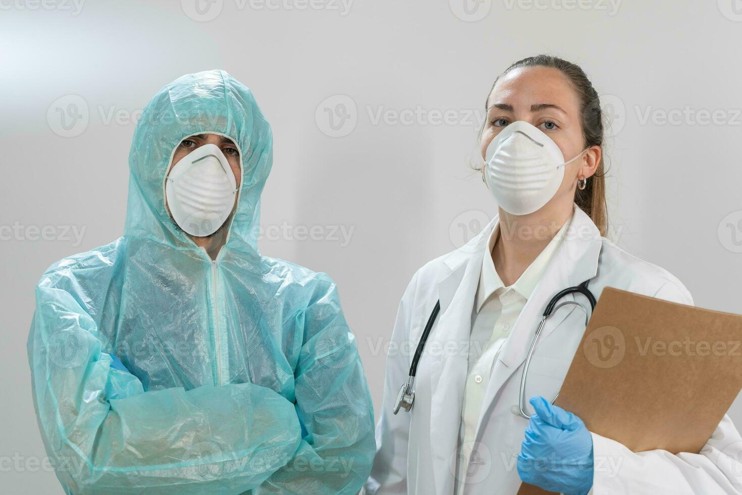 Doctors and nurses working in the hospitals and fighting the coronavirus. Doctors are heroes. Doctors in the protective suits and masks looking for a cure for the disease. photo