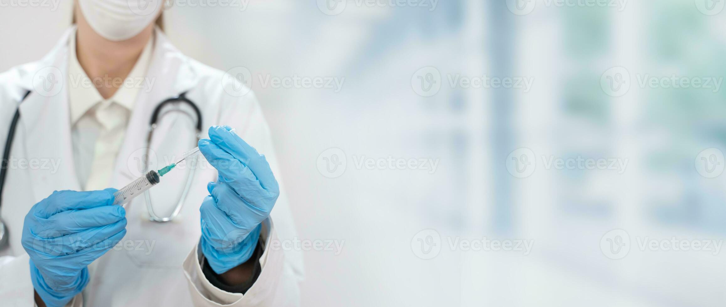 Banner with young attractive female doctor preparing vaccine syringe. photo