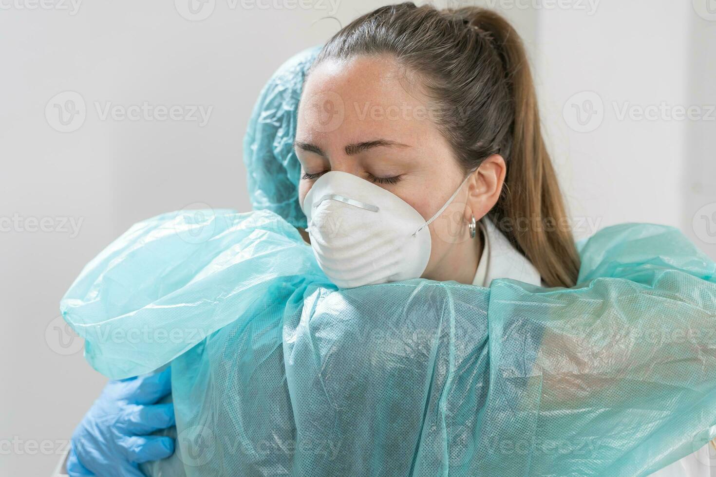 médico y enfermero abrazando a hospital y luchando vistiendo protector trajes y máscaras.. doctores son héroes genial equipo. compañerismo. foto