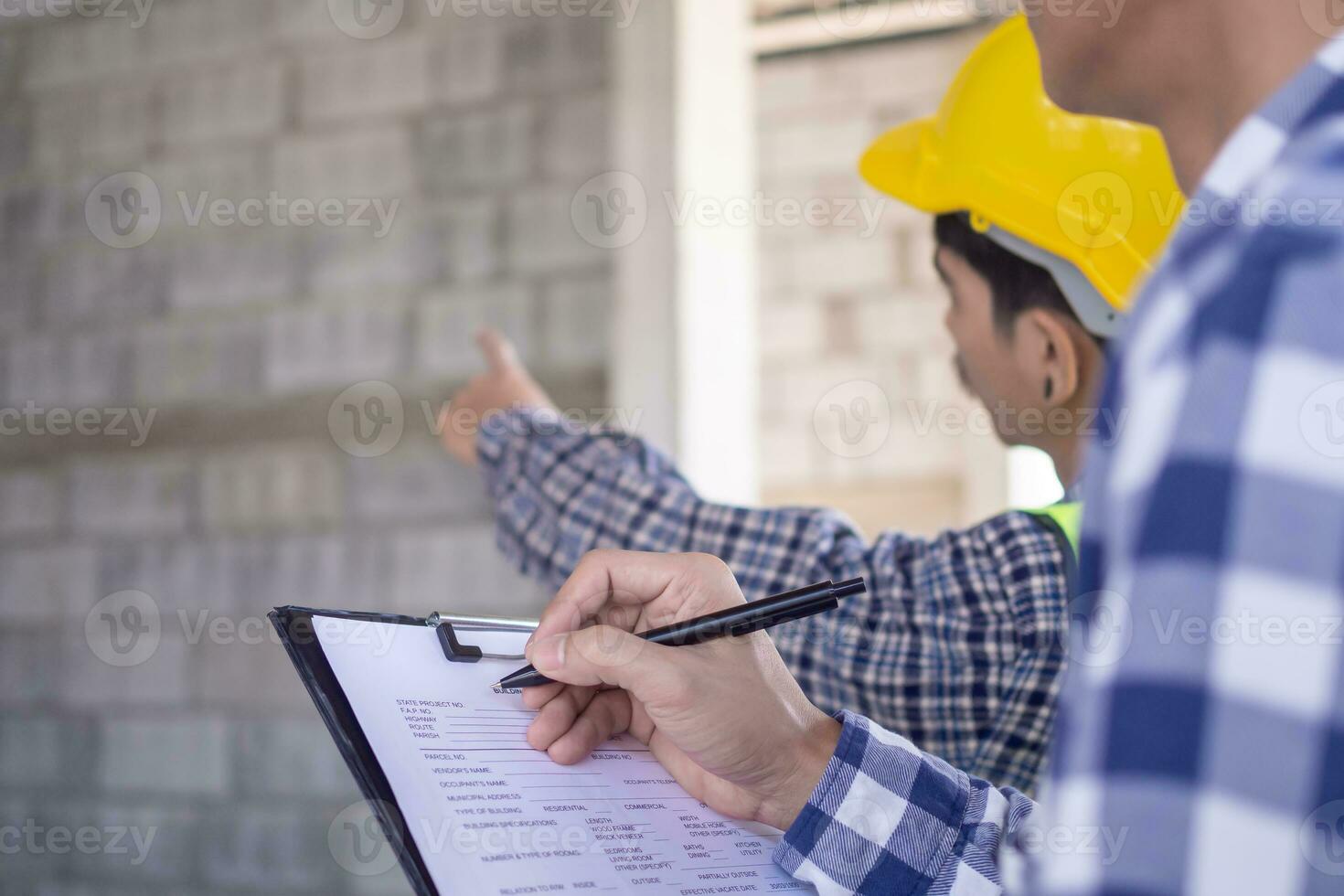 inspector or engineer is inspecting construction and quality assurance new house using a checklist. Engineers or architects or contactor work to build the house before handing it over to the homeowner photo