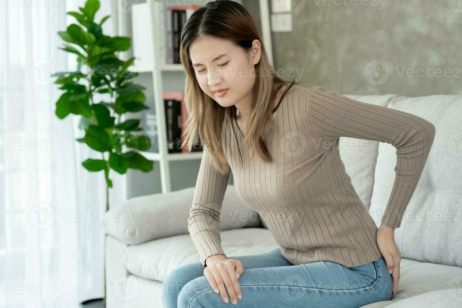 Suffering from scoliosis osteochondrosis after long study pretty young  Asian woman feel hurt joint back pain laptop in incorrect posture sit on  chair Stock Photo - Alamy