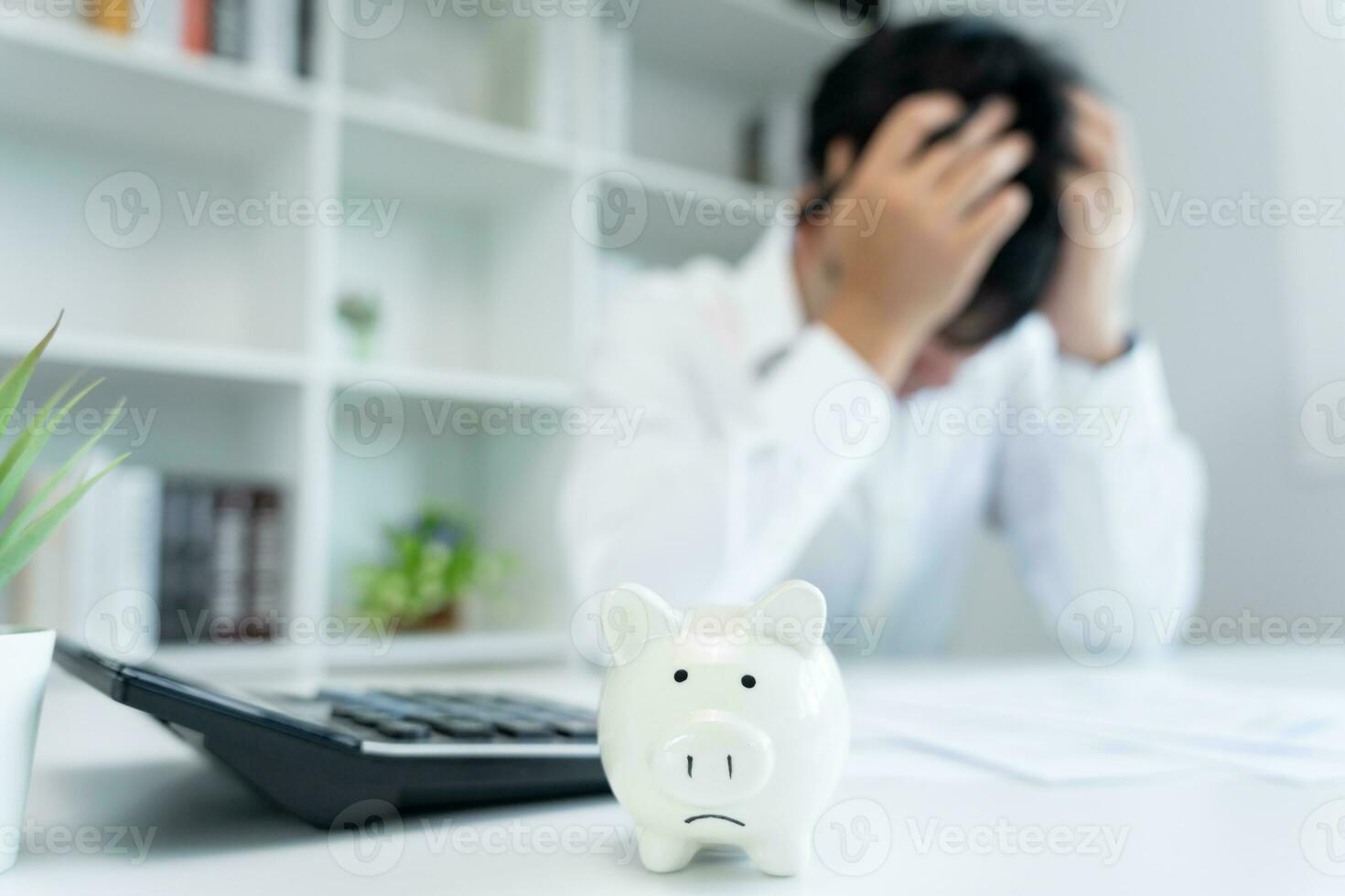 Stressed and headache asian man with large bills or invoices no money to pay to expenses and credit card debt. shortage, Financial problems, mortgage, loan, bankruptcy, bankrupt, poor, empty wallet photo