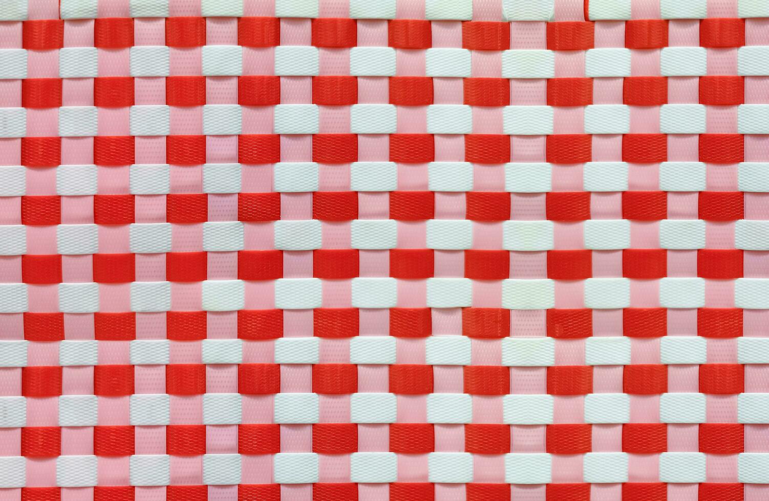 Colorful red and white weave pattern background of recycled plastic basket, recycle concept photo