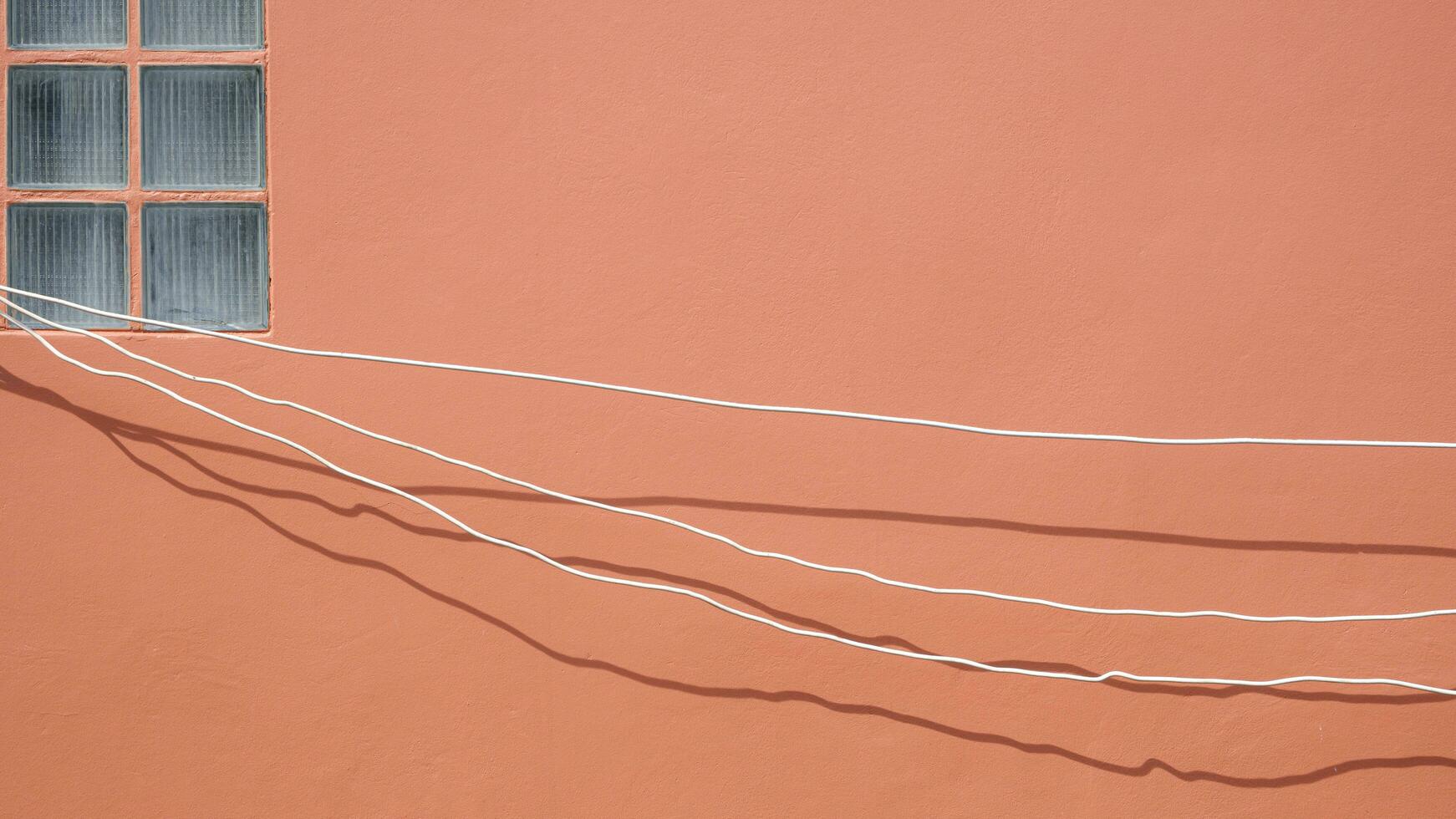 Minimal simplicity background of electrical cables are temporarily installed on brown wall for outside home improvement work photo