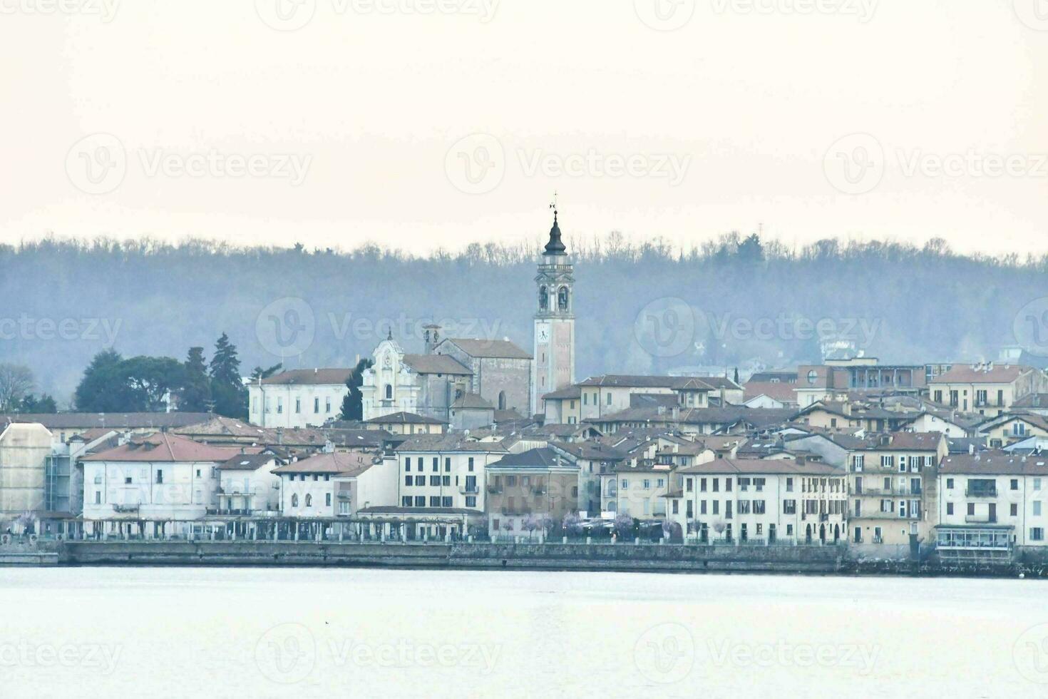 a view of a town with a church tower in the background photo