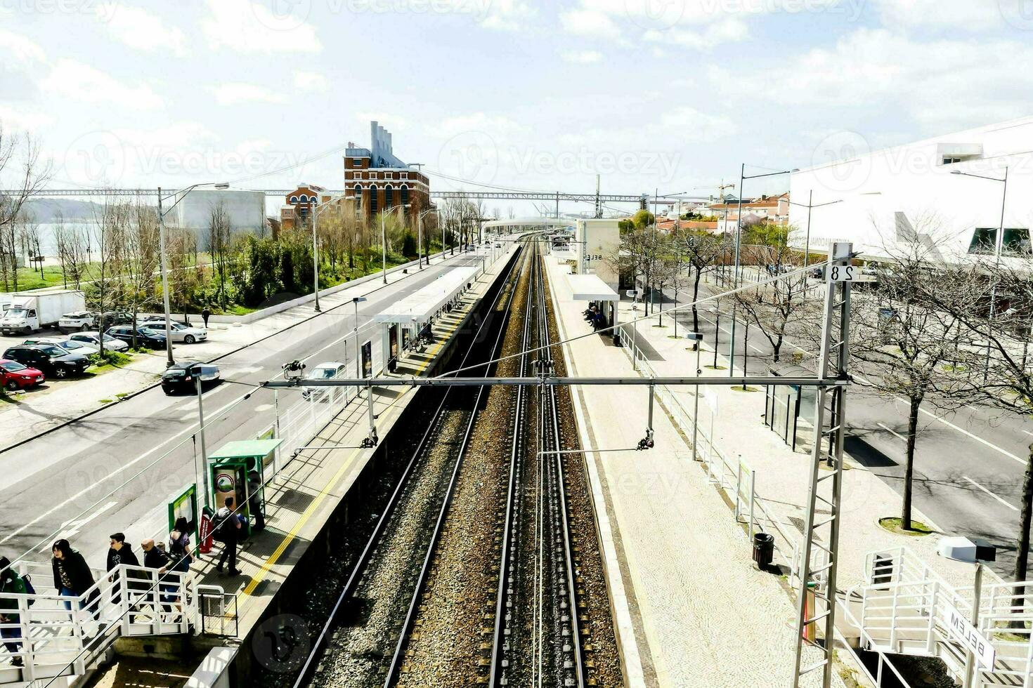 a train station and people walking on the platform photo