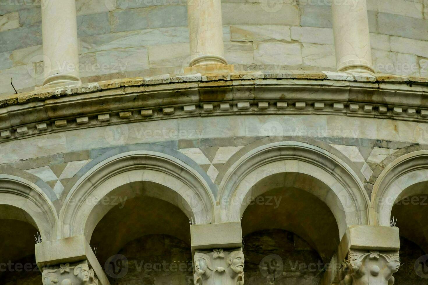 the top of a building with arches and columns photo