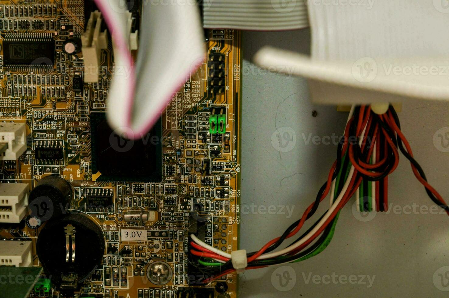 a close up of a computer motherboard with wires attached photo
