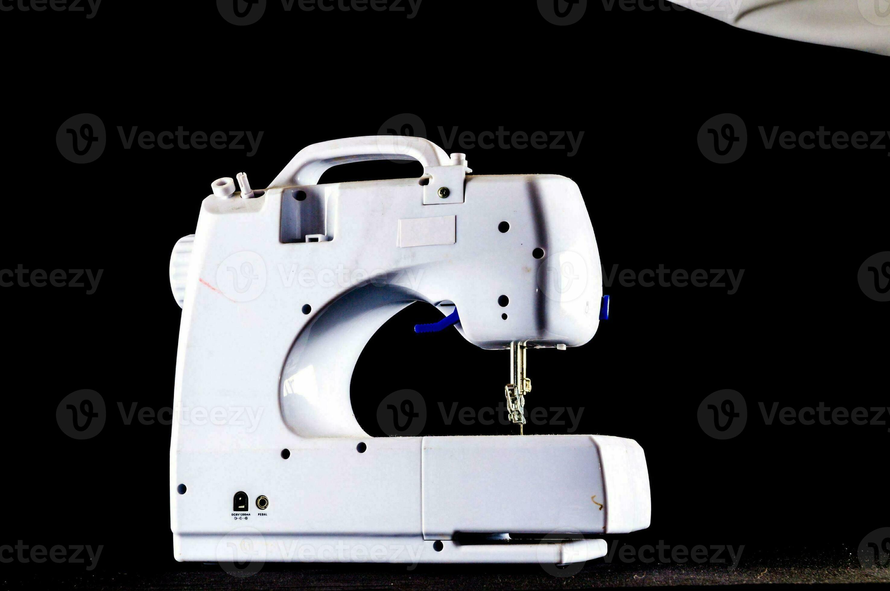 a white sewing machine on a black background 34978854 Stock Photo at