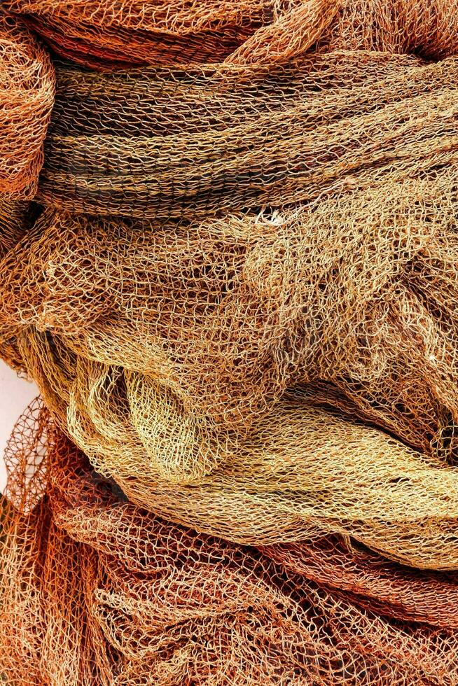 a pile of orange and brown fishing nets photo
