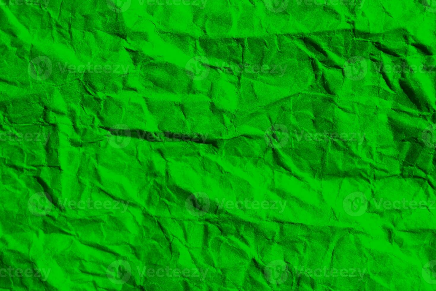 Wrinkled green paper texture background. Crumpled paper surface. photo