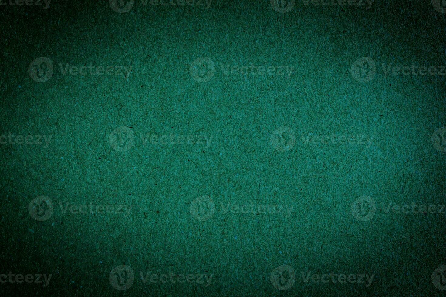 Green paper texture background. Abstract dark green surface for designs. photo