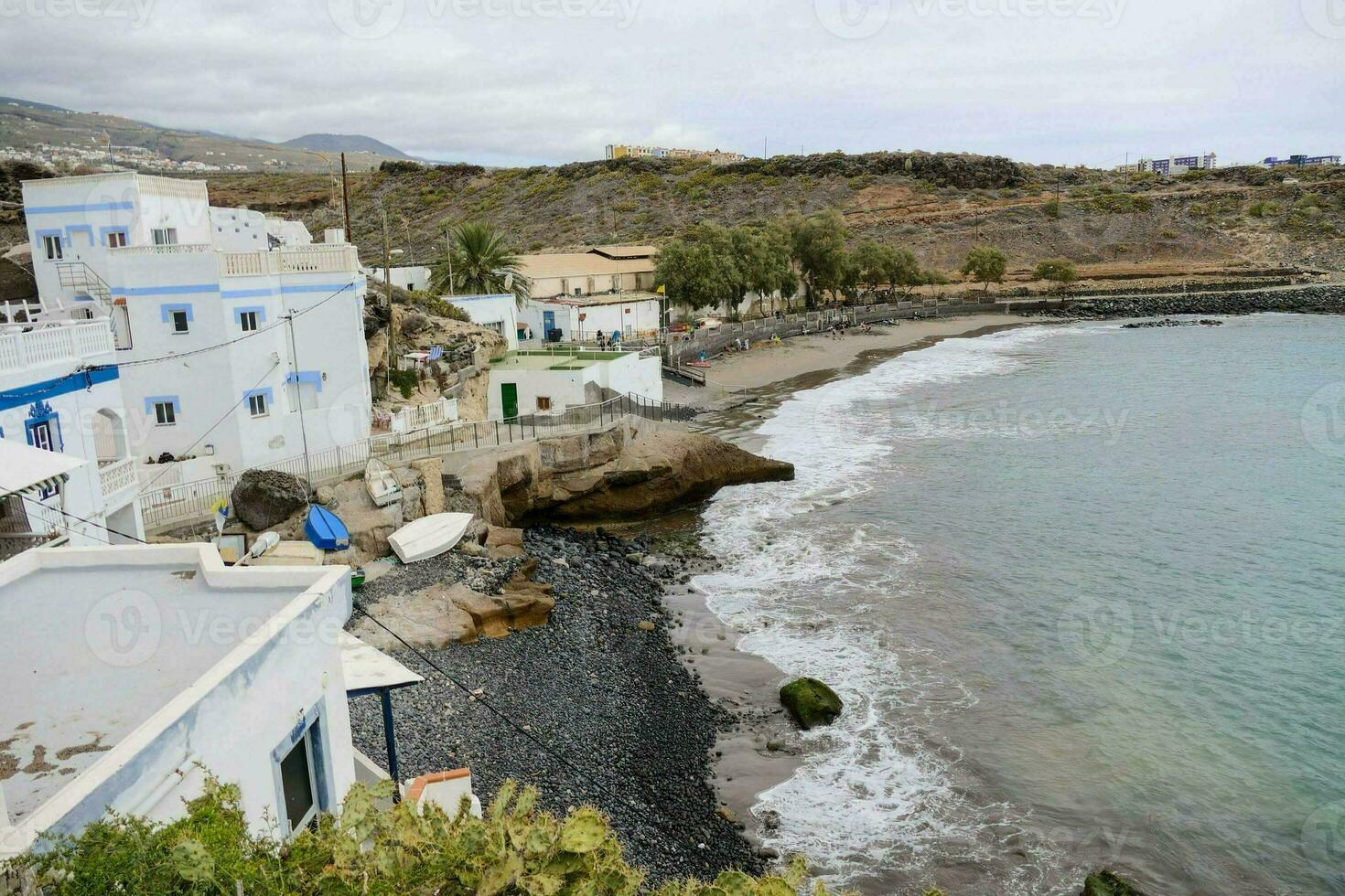 a view of the beach and houses on the coast photo