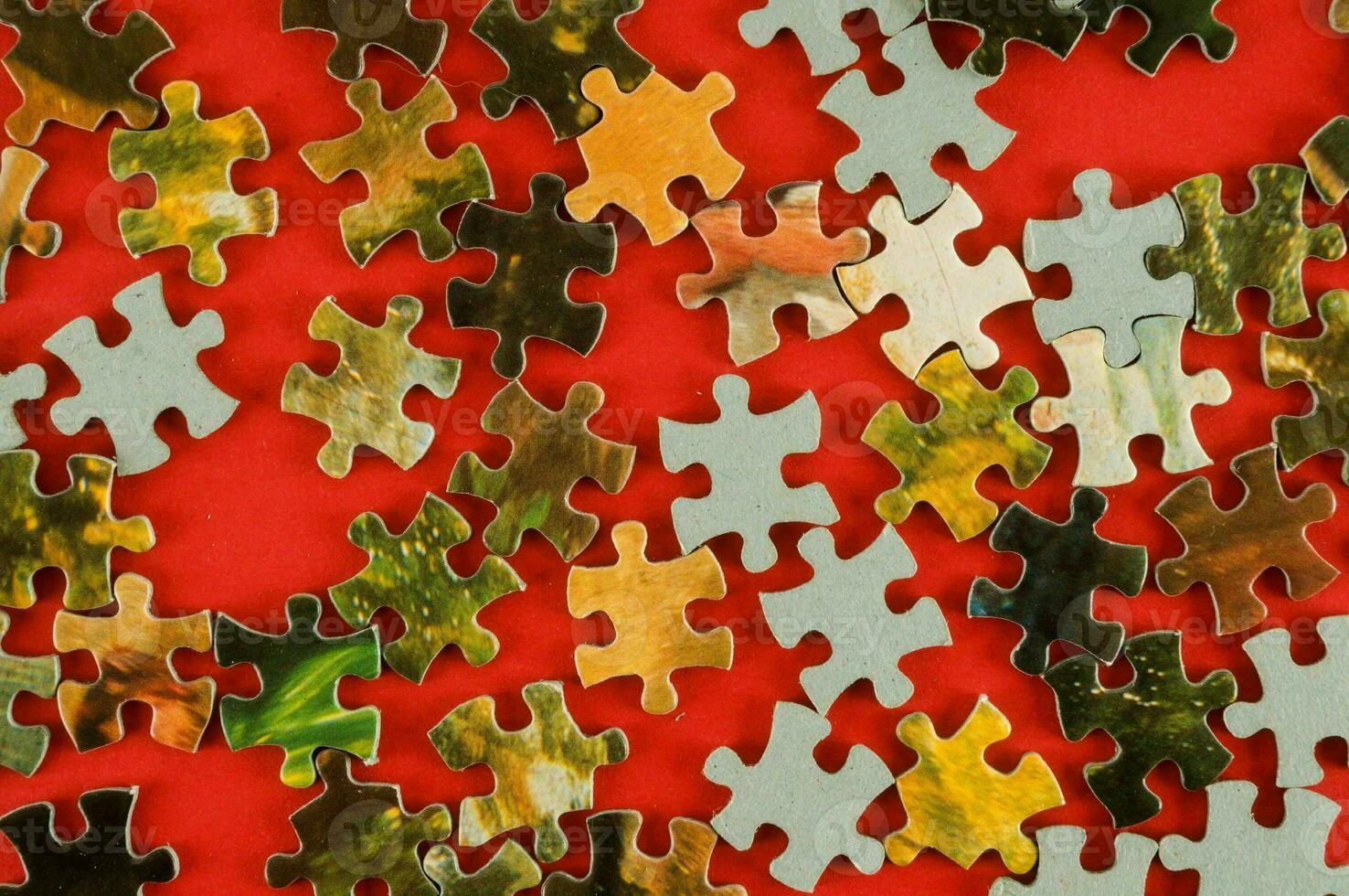 a red background with many pieces of puzzle photo