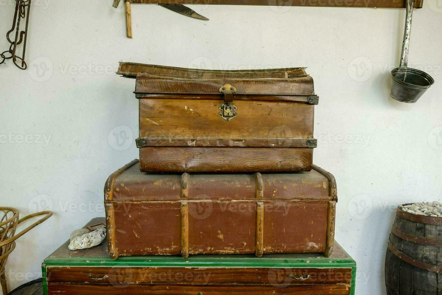 two old suitcases sitting on top of a wooden chest photo