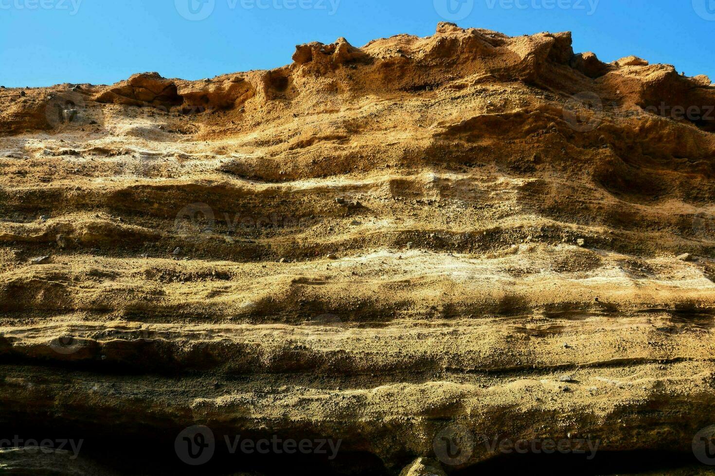 the rock formation is made of sand and dirt photo