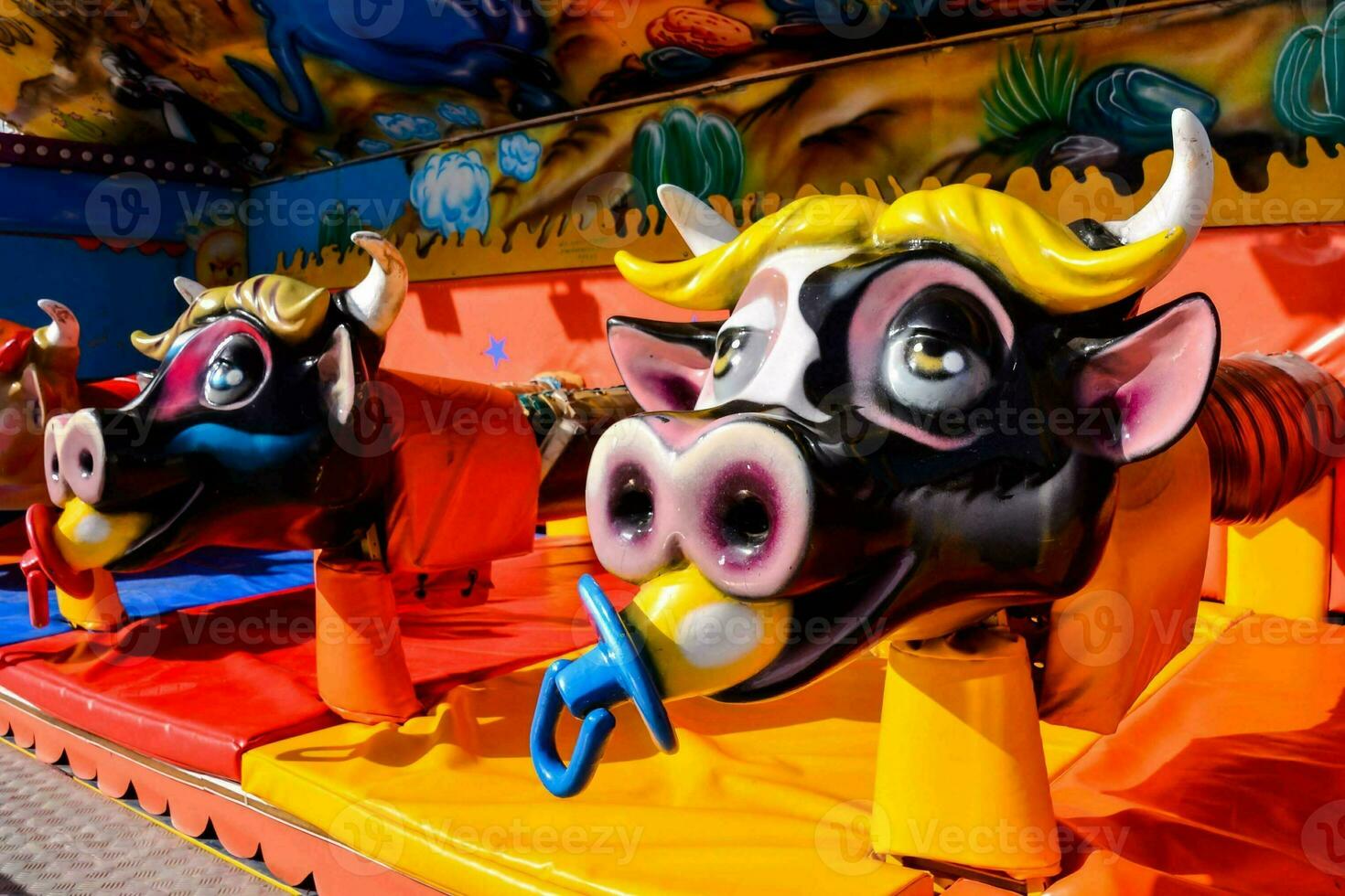 a carnival ride with two cow heads on it photo