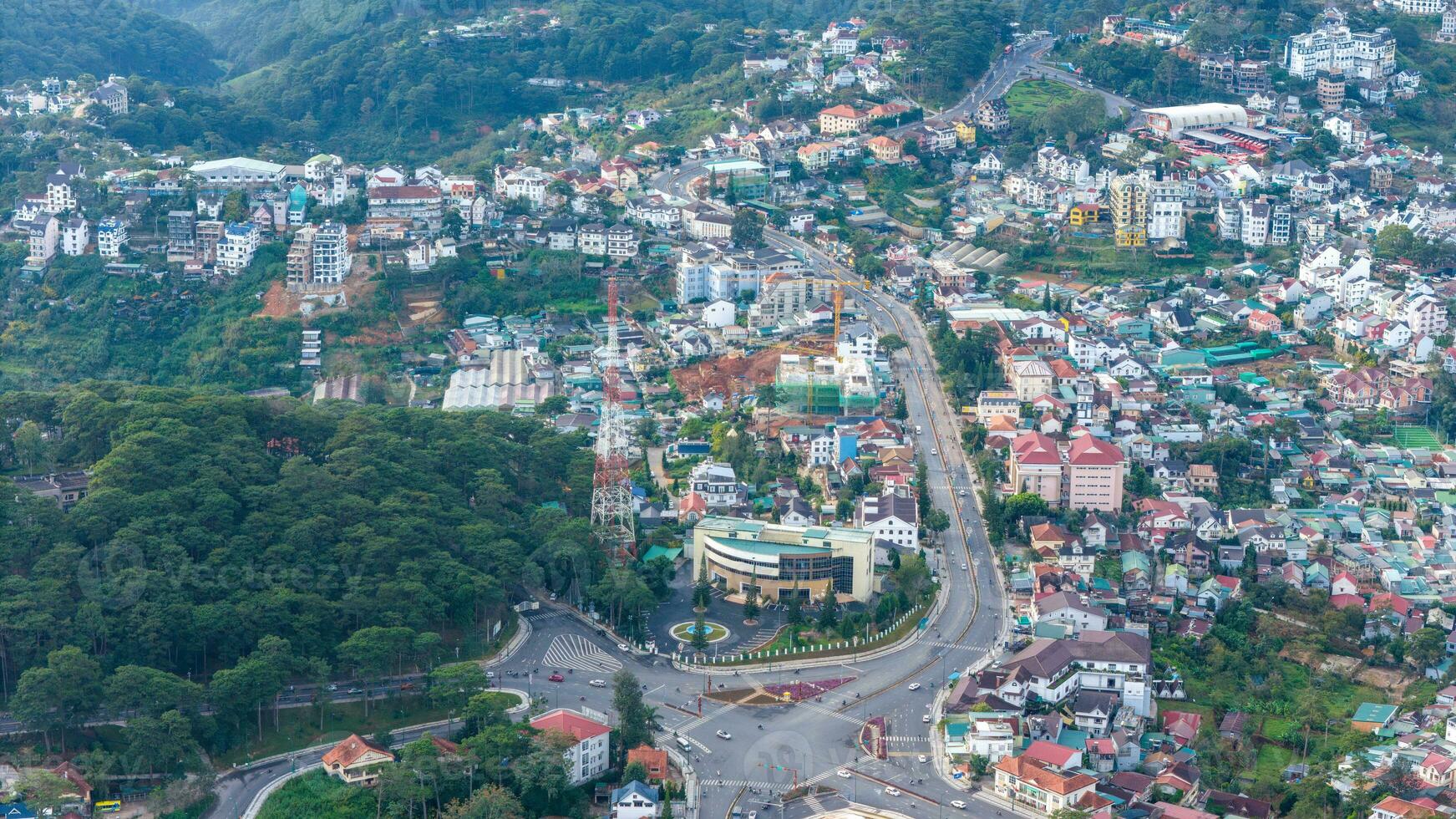 Aerial view of a Da Lat City with development buildings, transportation. Tourist city in developed Vietnam. Center Square of Da Lat city with Xuan Huong lake and market. photo