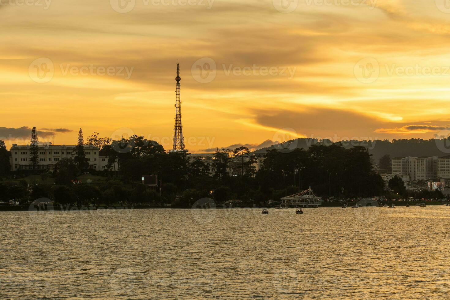 Sunset view of a Da Lat City with development buildings, transportation, market. Tourist city with center square of Da Lat city near Xuan Huong lake photo
