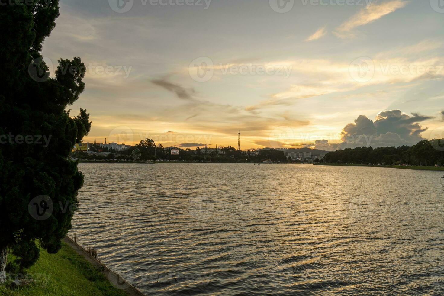 Sunset view of a Da Lat City with development buildings, transportation, market. Tourist city with center square of Da Lat city near Xuan Huong lake photo